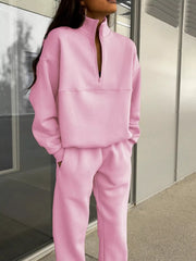 Blush pink half zip sweatshirt and matching pants set with a funnel neck and relaxed fit.