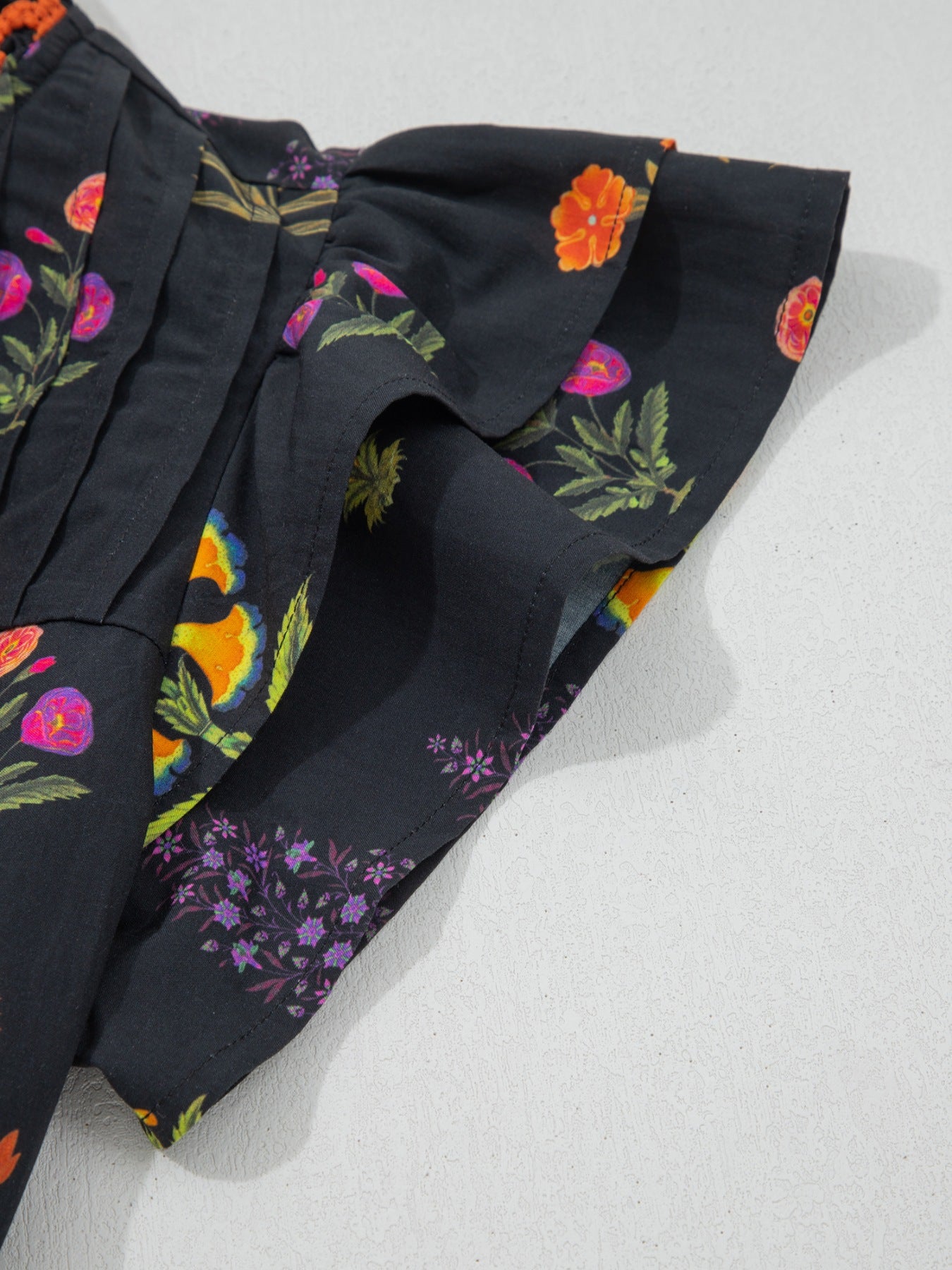 Black floral print cotton maternity shirt with V-neck and frill detail sleeves.