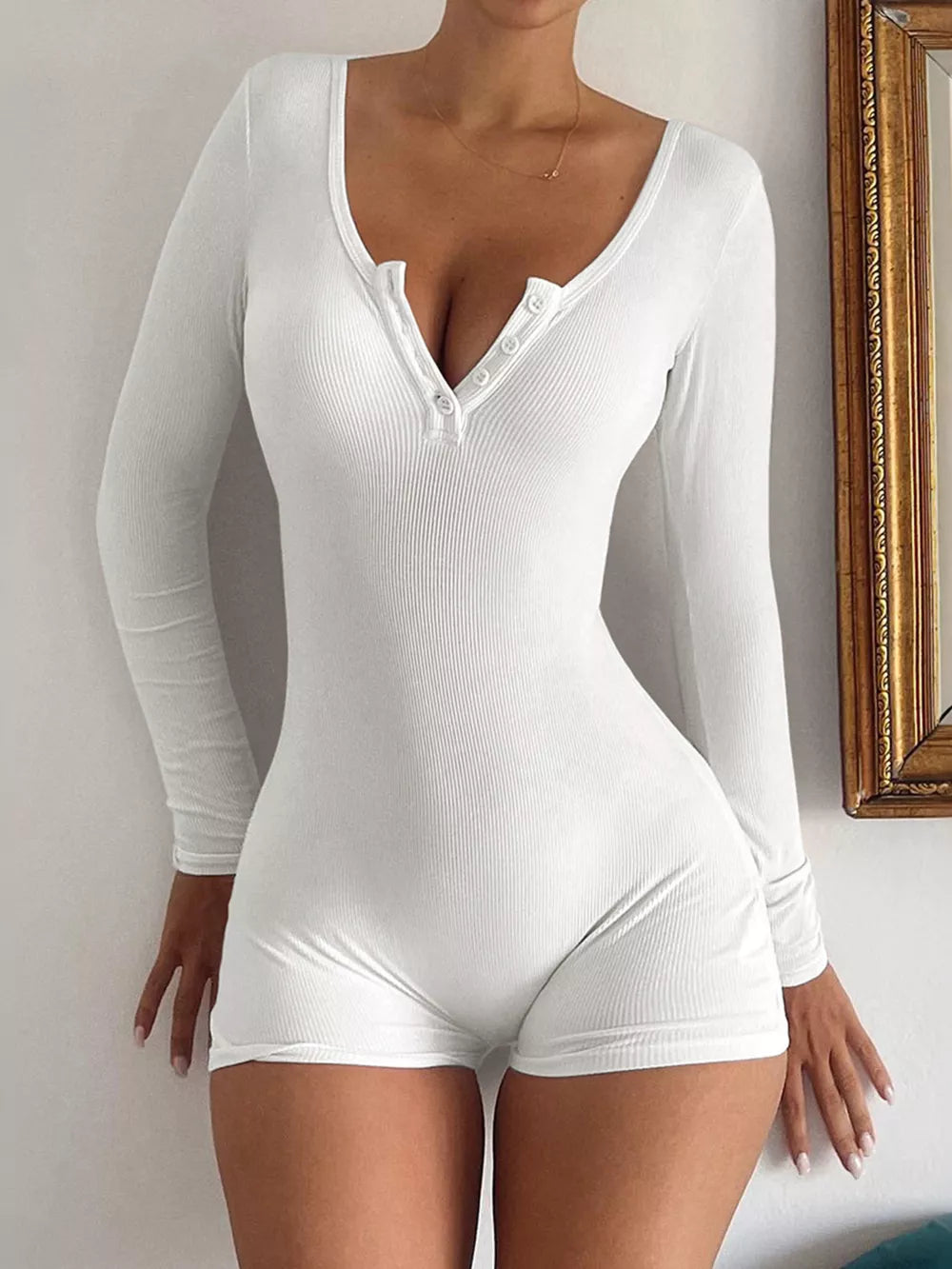 White ribbed knit long sleeve romper with button-down neckline and short legs