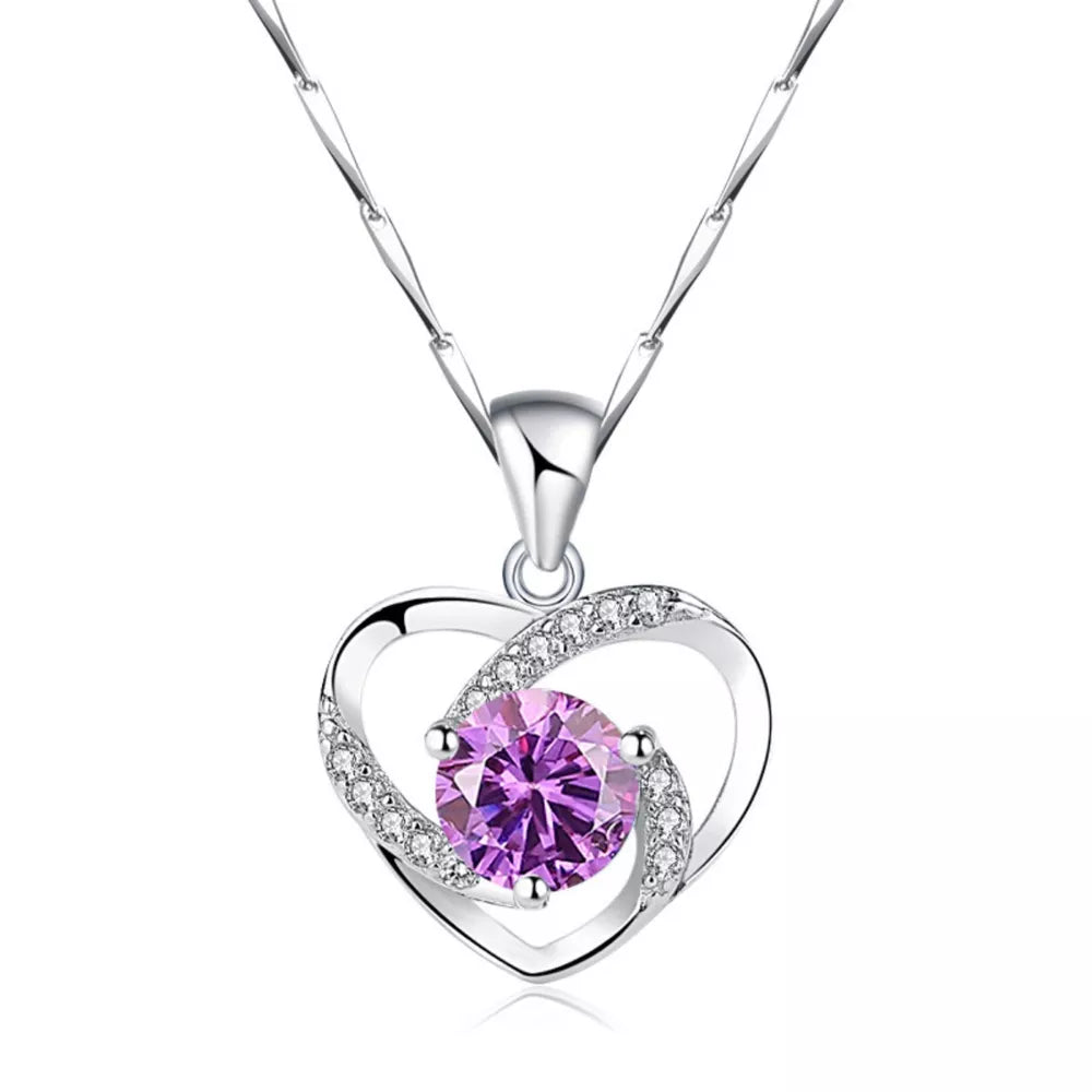 Silver heart pendant necklace with a lavender zircon and clear crystals.