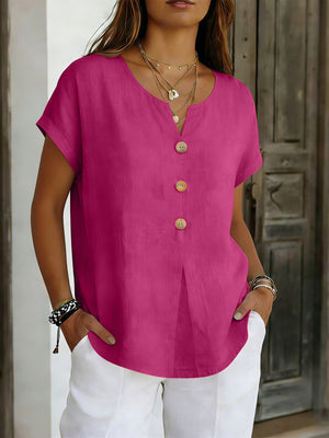 Buttoned short sleeve blouse in cerise with wooden buttons and a V-neckline.