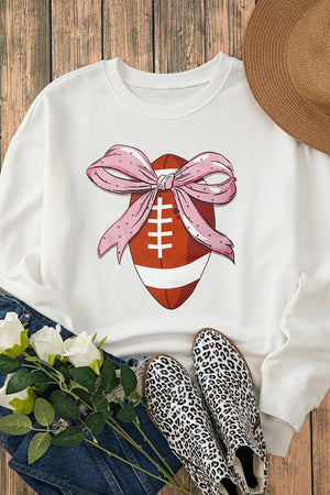 White crewneck sweatshirt with a football graphic adorned with a pink polka dot bow.