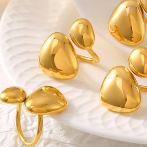 Gold bypass ring with sculptural pebble details.