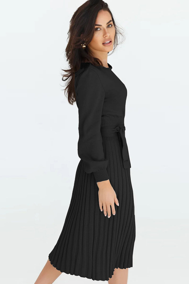 Black belted pleated knit midi dress with long sleeves and tie waist.