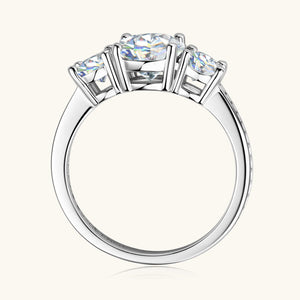 Trio moissanite ring in silver, featuring three round-cut stones and a pavé band.