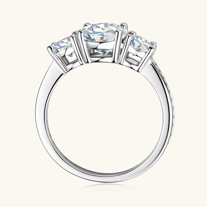 Trio moissanite ring in silver, featuring three round-cut stones and a pavé band.