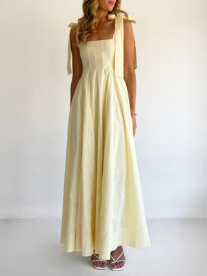 Yellow maxi dress with square neckline and bow-tie shoulder straps