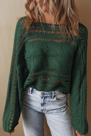 Dark green acrylic cable knit sweater with cutout details and long sleeves.