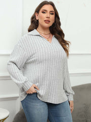 Relaxed ribbed polo top in light grey with a collared neckline and long sleeves.