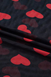 Sheer mesh blouse with red heart print on black fabric