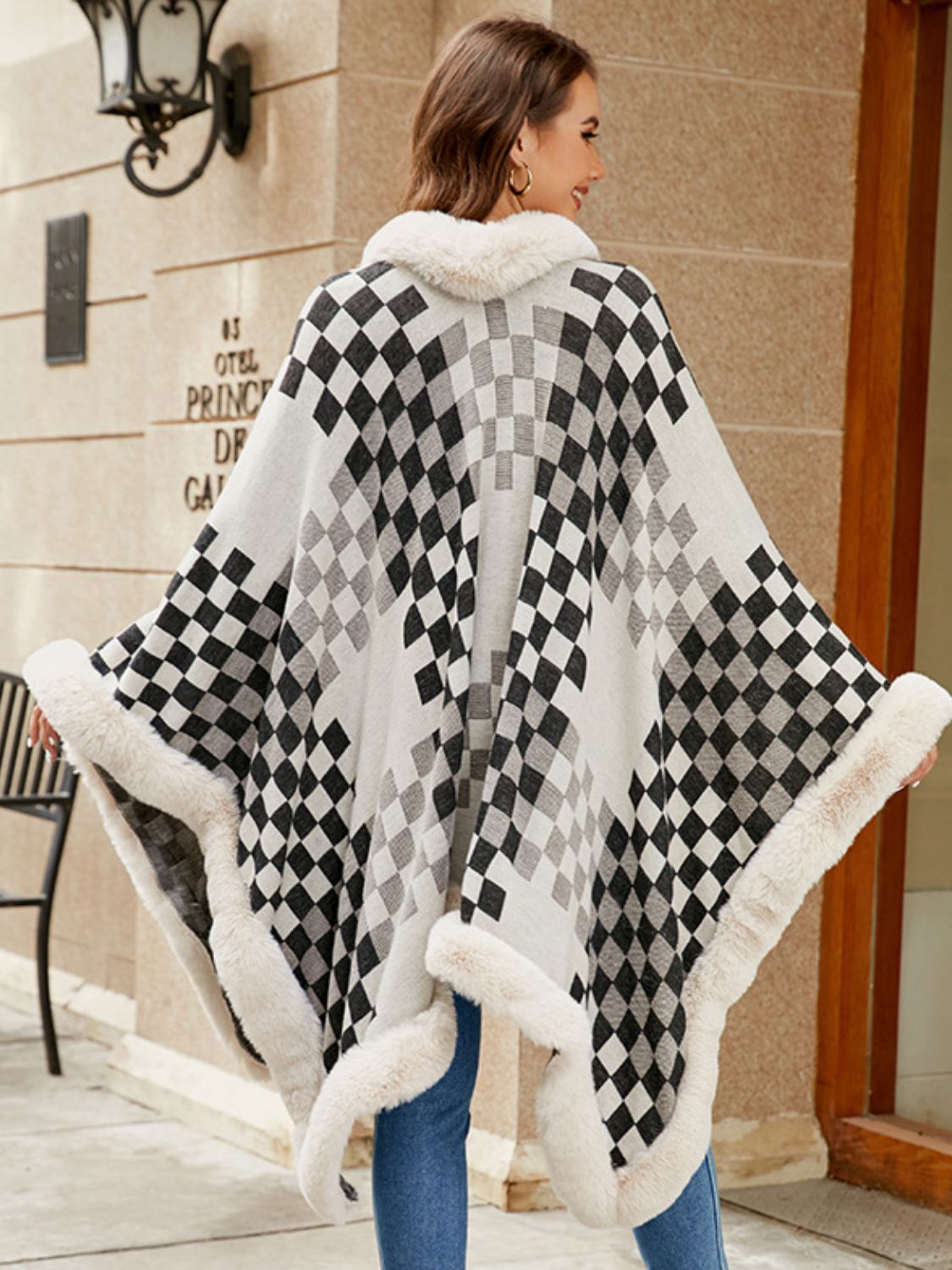 Checkered cape with faux fur trim in black and white, acrylic, open front, cozy winter outerwear.