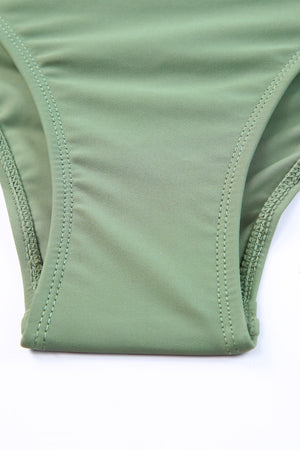 Sage ruched bodice halter swim dress detail showing stitching and fabric.
