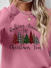 Blush pink crewneck sweatshirt with graphic Christmas trees and text.