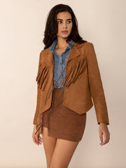 Caramel suede western jacket with fringe and tie detail, collared, long sleeves.