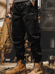 Men's black relaxed fit cargo pants with elastic cuffs and large side pocket.
