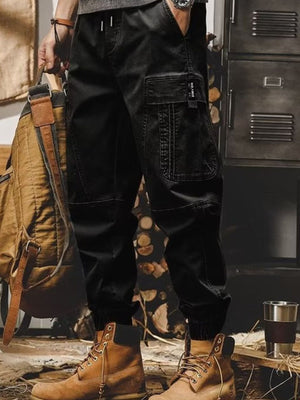 Men's black relaxed fit cargo pants with elastic cuffs and large side pocket.