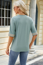 Light green textured V-neck top with lace trim on sleeves.