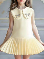 Toddler bow dress in apricot with lace trim.