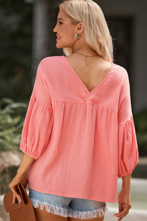 Textured gauze blouse in Burnt Coral with gathered sleeves and V-neck