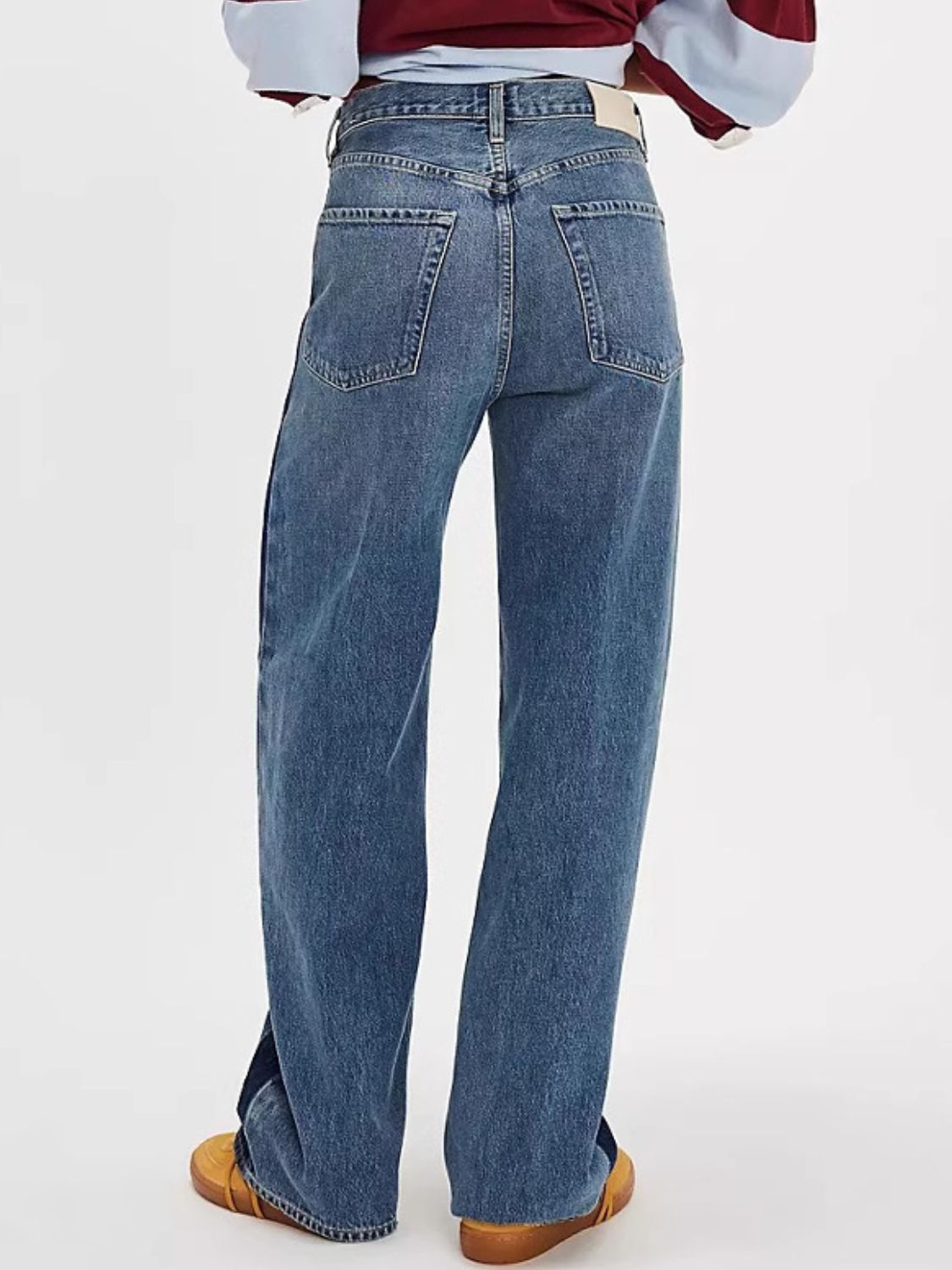 Dusty blue wide-leg jeans with contrast side panels and a buttoned fly.