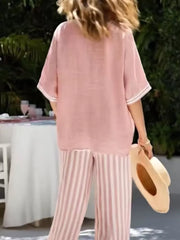 Pink striped wide-leg pants and matching short-sleeve V-neck top with white trim