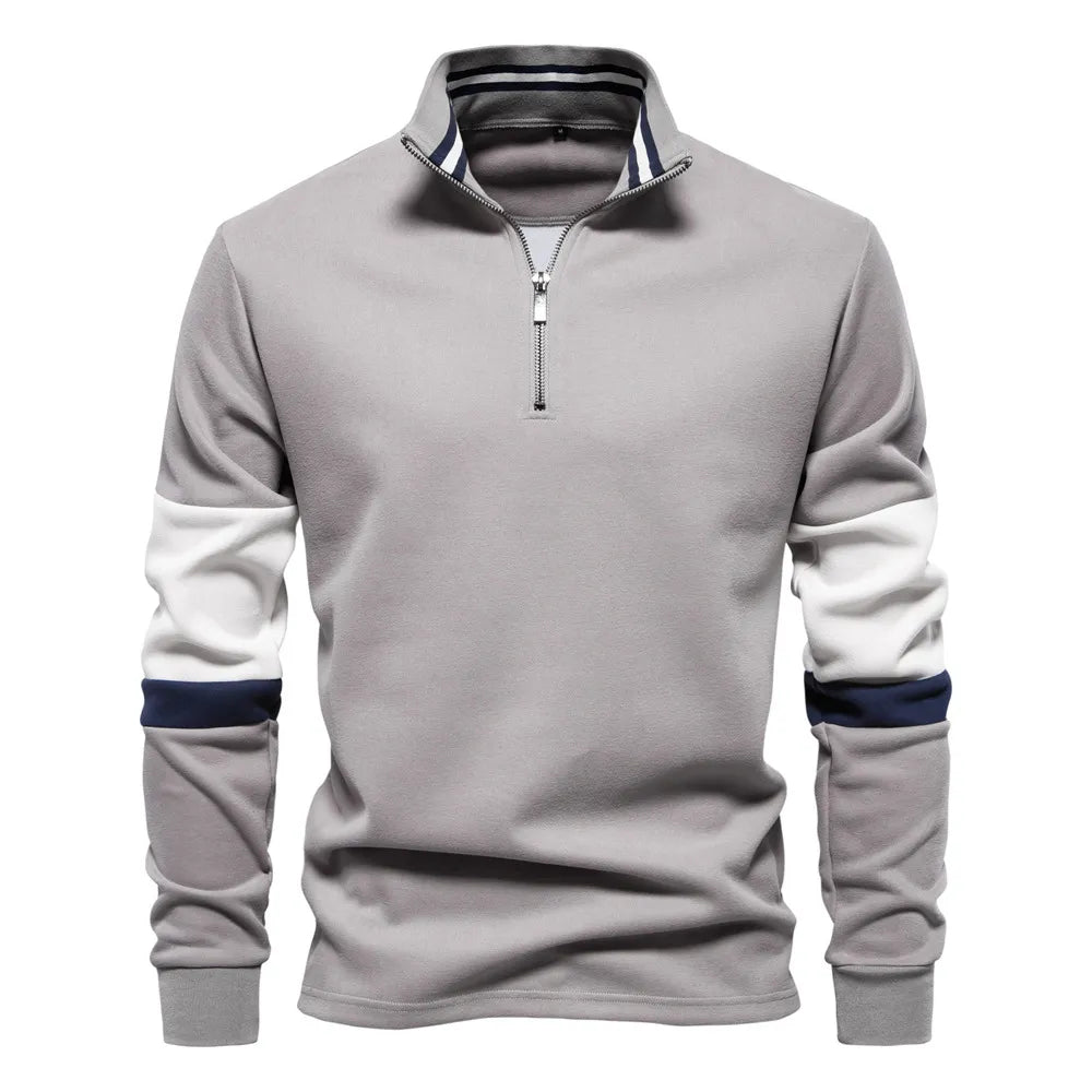Gray zip-neck sweatshirt with colorblock sleeves and striped collar detail.