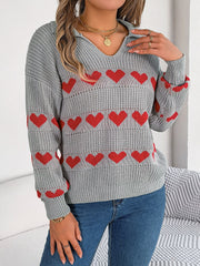 Gray knit polo sweater with red heart stripe pattern and collared neckline.