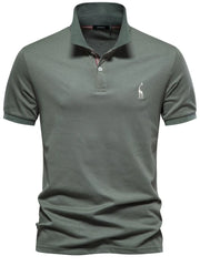 Moss green piqué polo shirt with giraffe embroidery and striped collar detail.