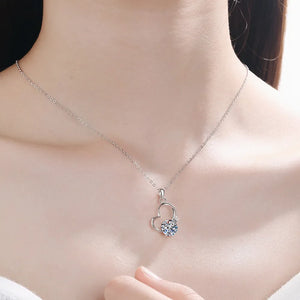 Silver heart halo pendant necklace with a clear gemstone accent