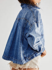 Oversized denim trucker jacket in light blue wash with button closure and pleated back detail.