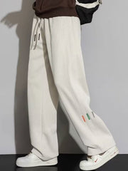 Men's apricot casual loose fit drawstring sweatpants with side detail tags.