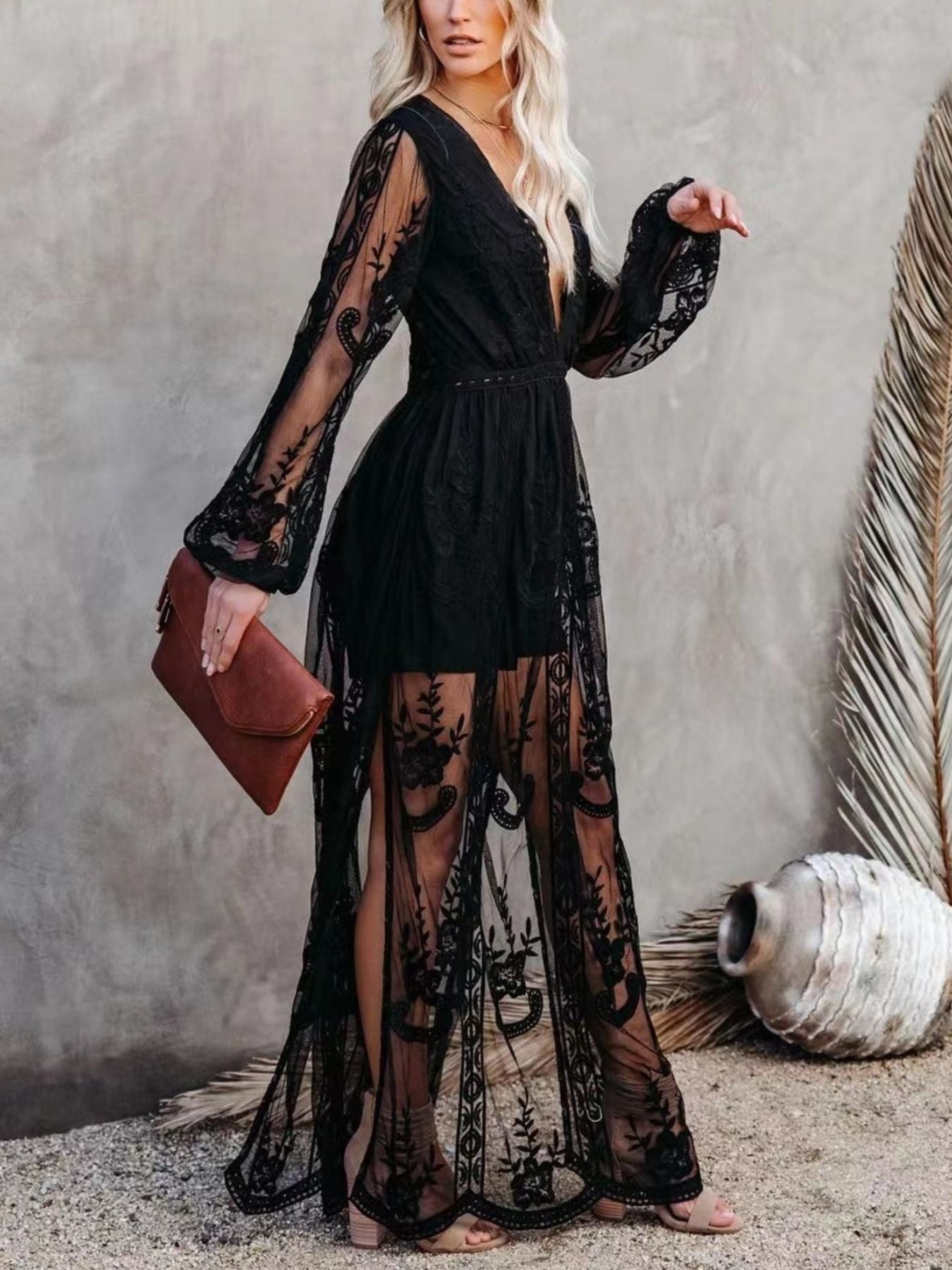 Black floral lace maxi dress with plunging neckline, bell sleeves, and a high slit.