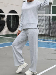 Light gray sweatpants with a relaxed fit and drawstring waist, part of a two-piece set.