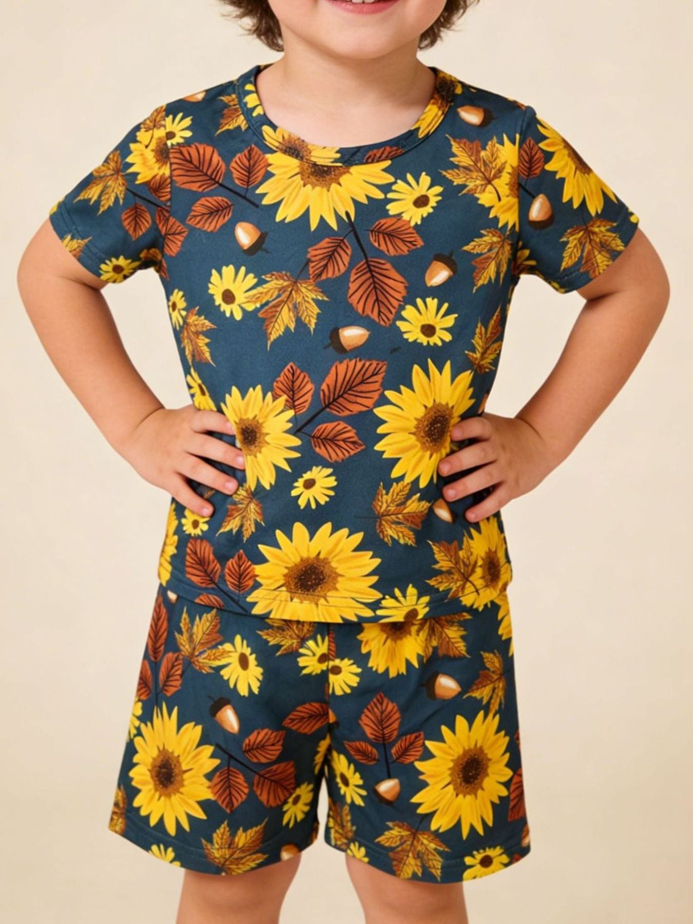Toddler blue short sleeve t-shirt and shorts set with sunflowers, leaves, and acorns pattern.