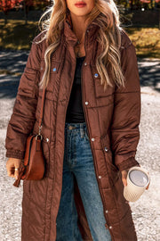 Brown quilted longline puffer coat with patch pockets and silver snap details.