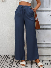Navy blue high-waist wide-leg pants with drawstring and pockets.