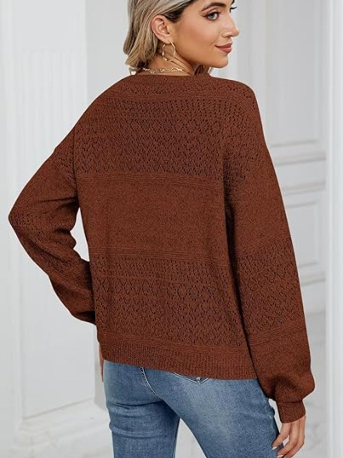 Brown diamond eyelet knit sweater with V-neck and long sleeves.