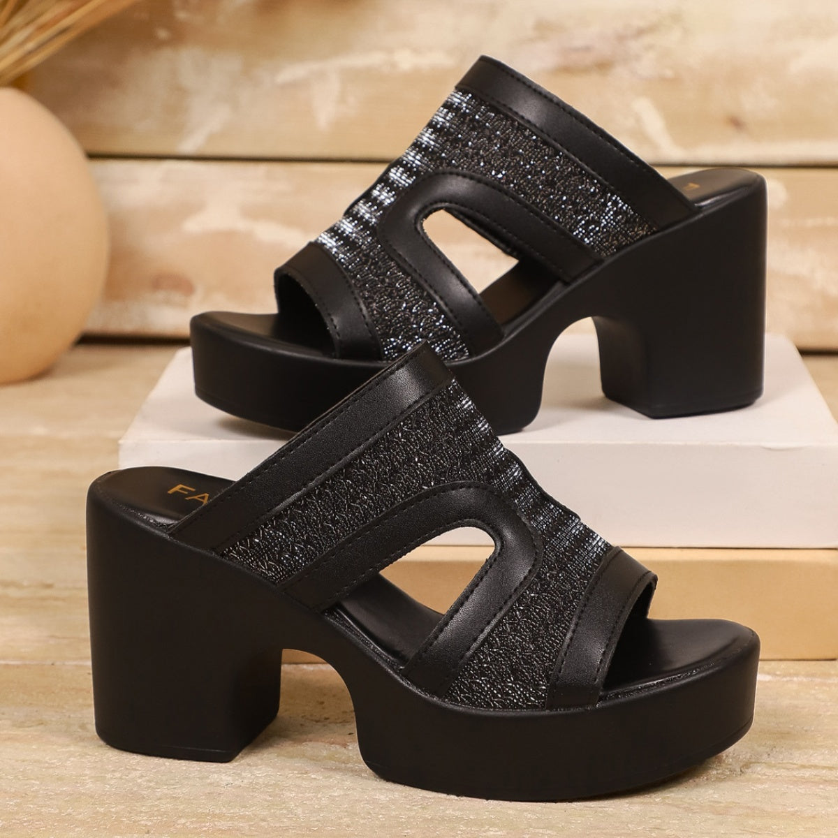 Black open-toe block heel sandals with cut-out details and sparkly embellishments.