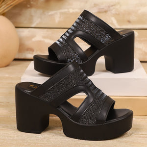 Black open-toe block heel sandals with cut-out details and sparkly embellishments.