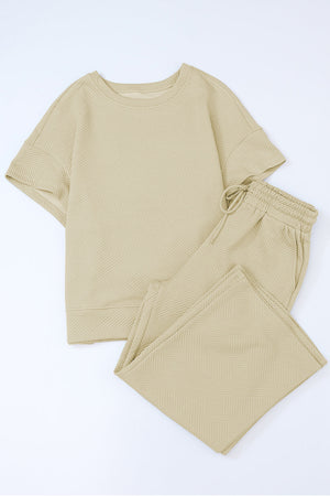Textured knit tee and wide leg pants set in beige with a geometric pattern.