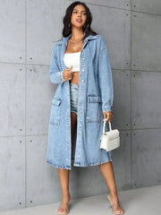 Denim duster coat in medium wash with long sleeves, collared neckline, button front, and utility pockets.
