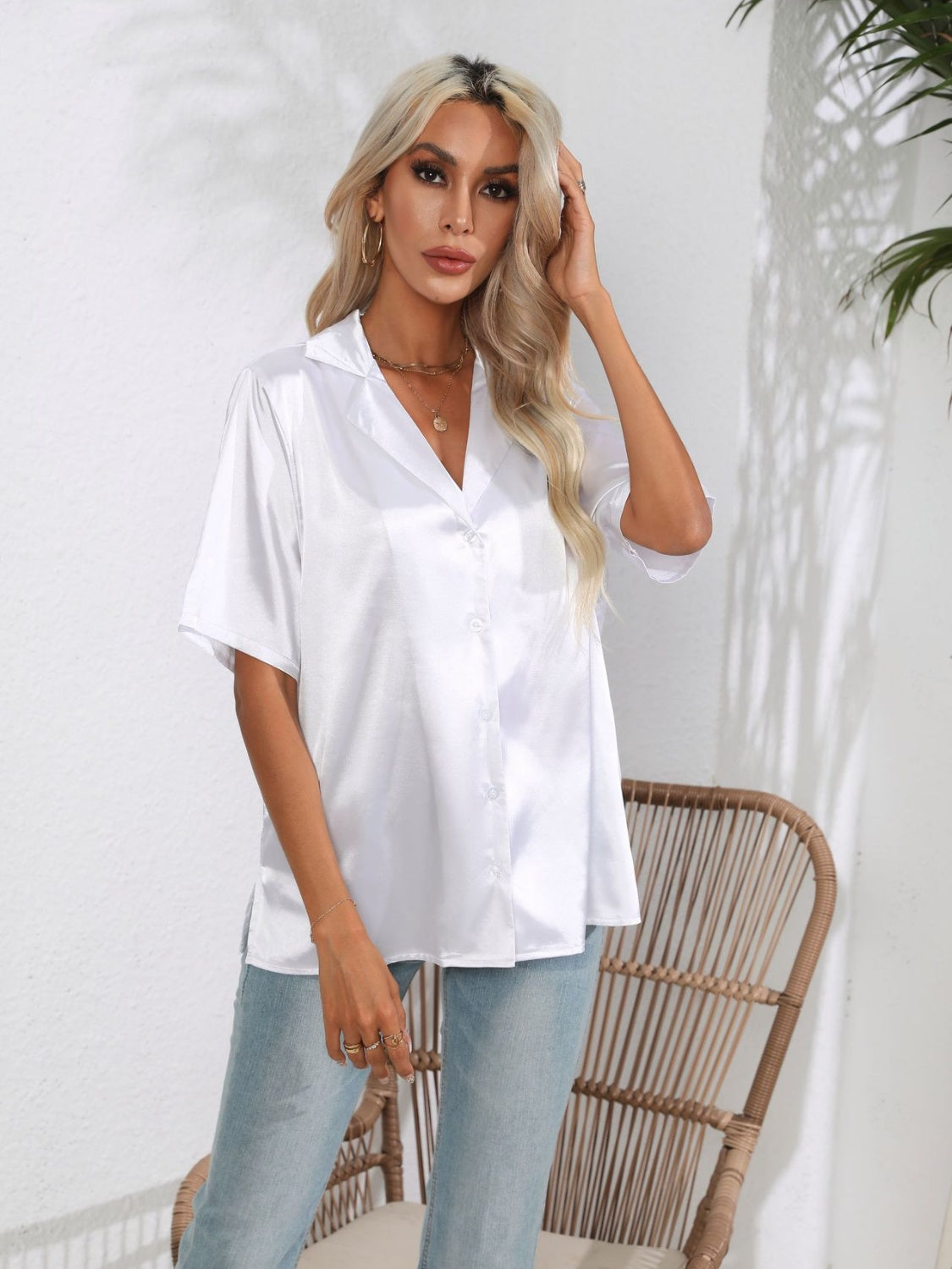 White satin collared shirt with button front and short sleeves.