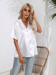 White satin collared shirt with button front and short sleeves.