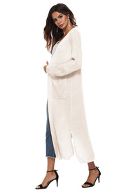 Longline ivory knit cardigan with pockets and side slits.