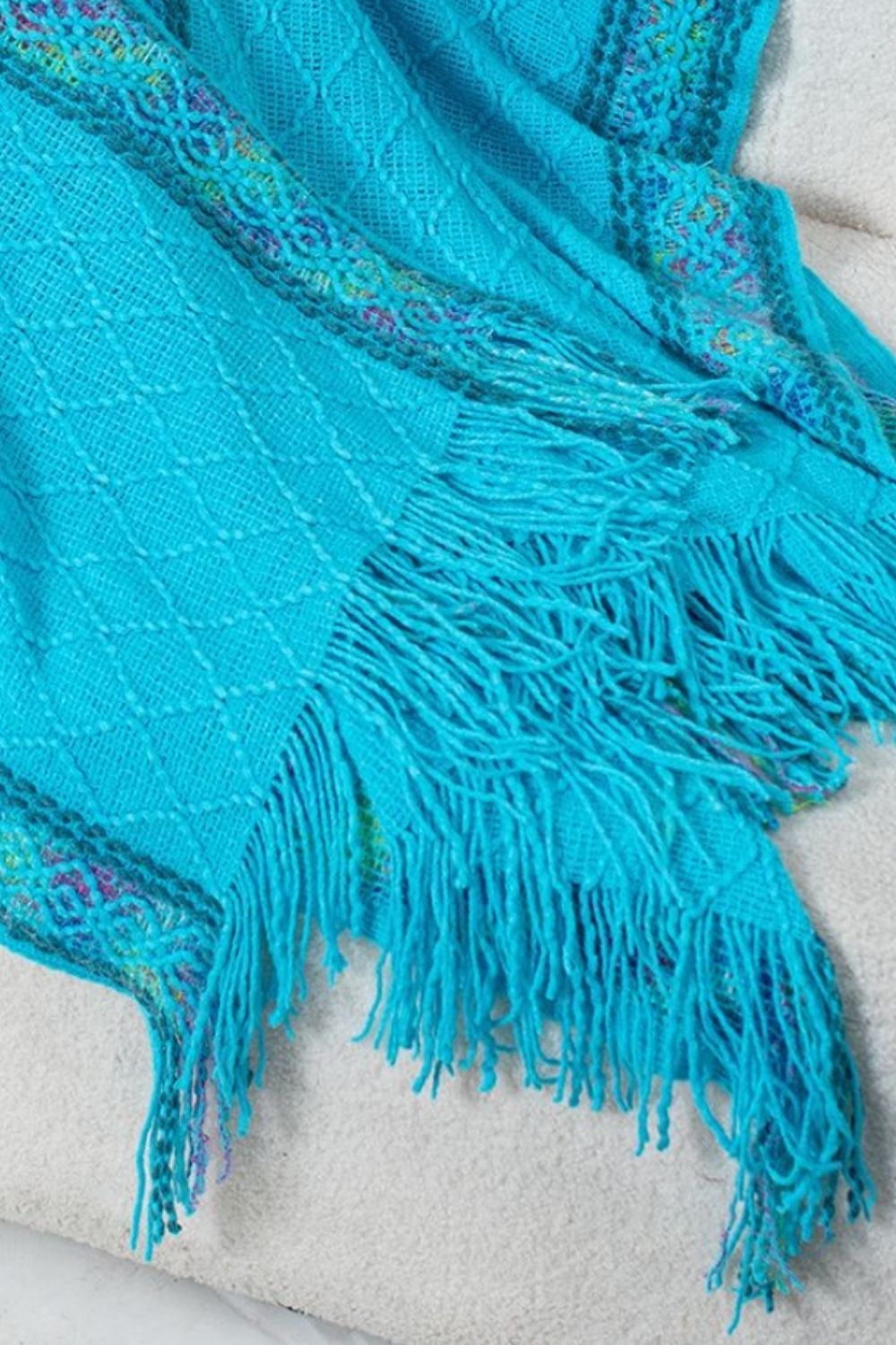Sky blue acrylic knit hooded wrap with embroidered trim and fringe detail