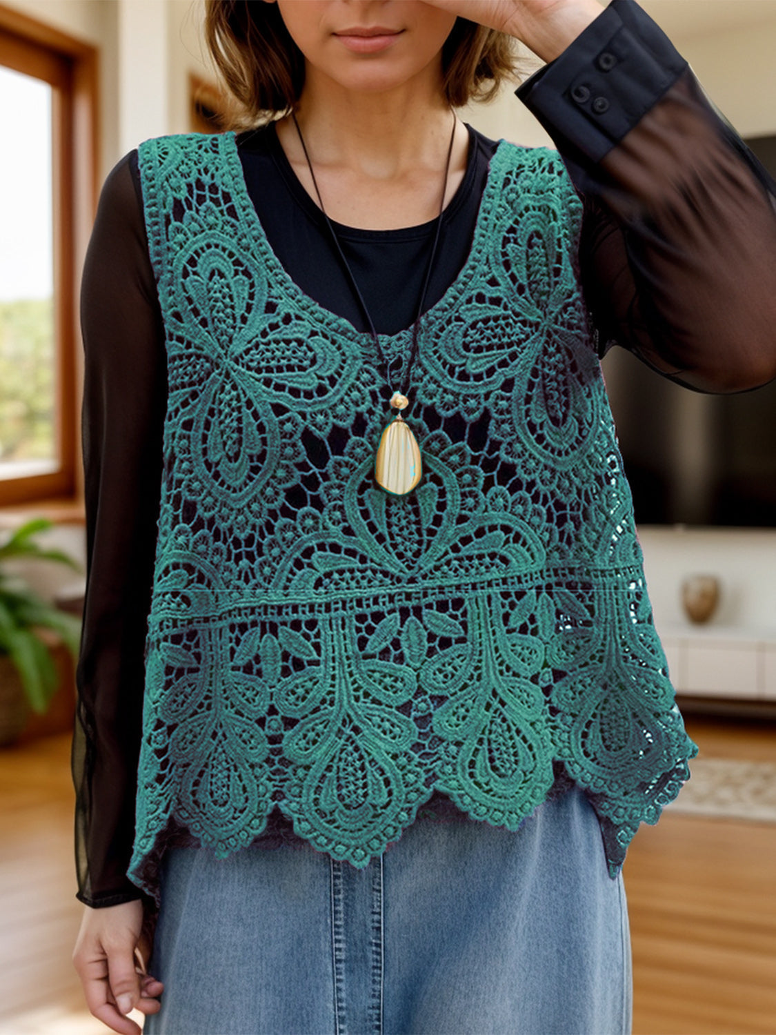 Turquoise lace overlay cropped vest with intricate floral pattern and scalloped hem.
