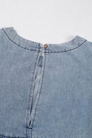 Gathered waist denim mini dress in medium wash with button closure at back neck.