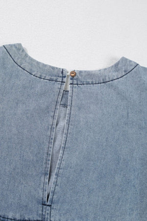 Gathered waist denim mini dress in medium wash with button closure at back neck.