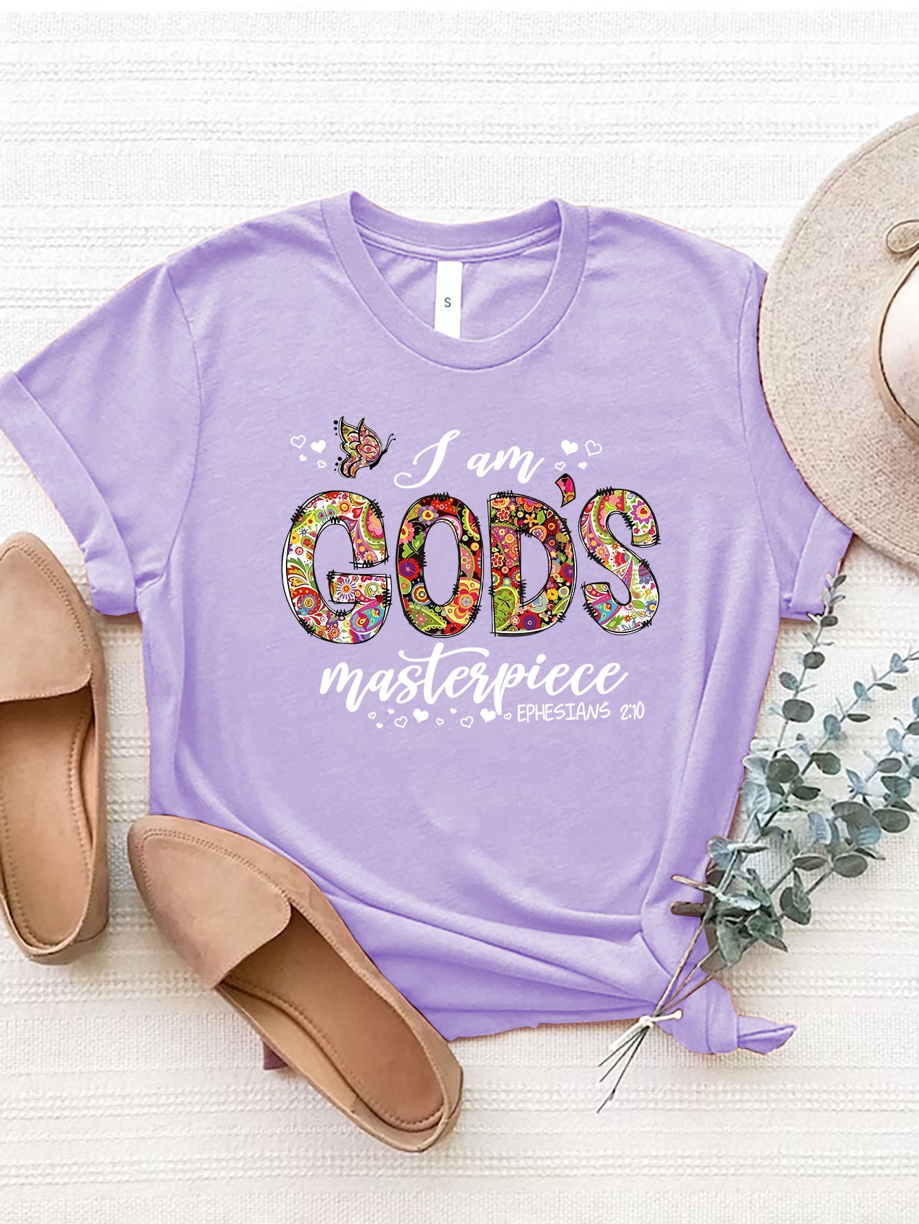 Lavender t-shirt with floral typography graphic saying I am God's masterpiece.