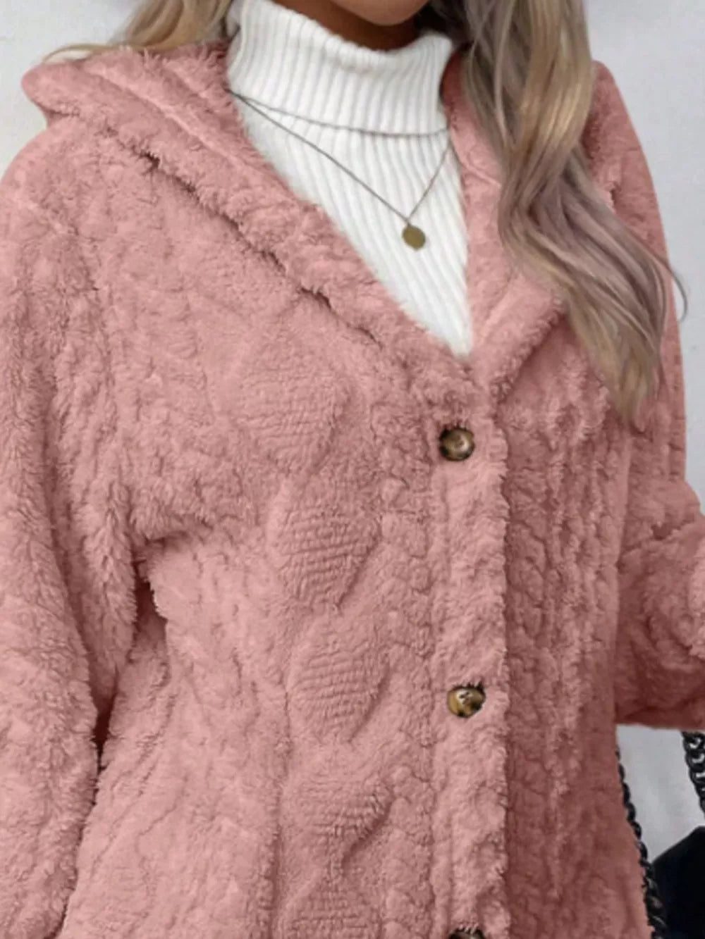 Pink hooded fuzzy coat with cable knit texture and button detail